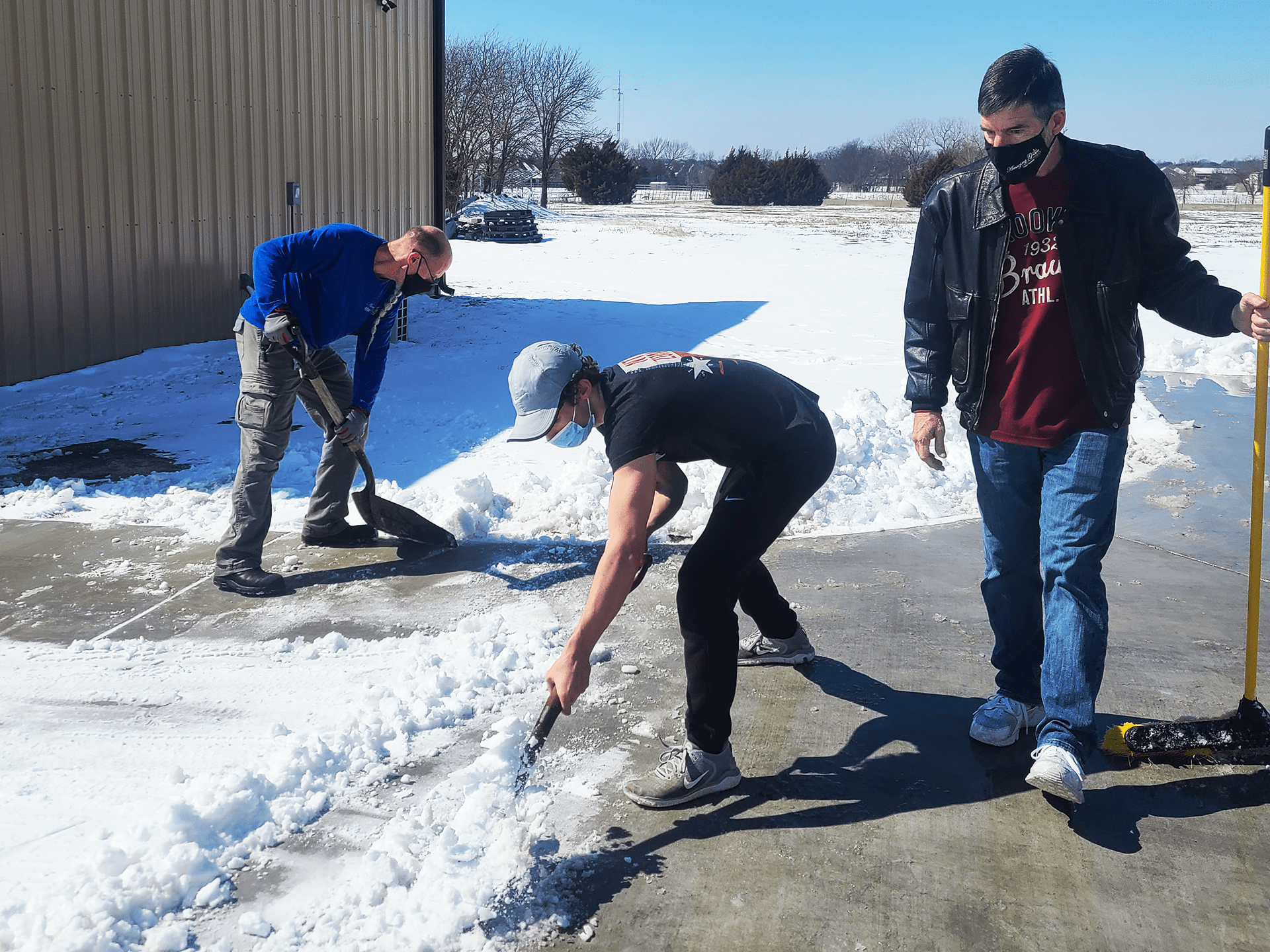 Volunteers cleaning snow at Amazing Grace Food Pantry